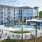 Pergola covered seating and cabanas surround saltwater pool at The Laurent at Carolina Forest