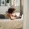 Resident lays on bed and works on her laptop