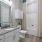 Ample lighting in apartment bathroom with shower/tub combo at The Laurent at Carolina Forest