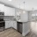 Apartment kitchen opening up to large living room at The Laurent at Carolina Forest